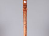 the flute is made of wood and has a wooden body