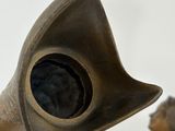 a bronze sculpture of a man playing a trumpet