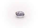 a close up of a purple diamond on a white surface