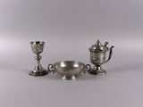 two silver cups and a bowl on a white surface