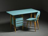 turquoise desk and chair in a dark room with a black wall