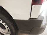 a close up of a white van with a flat tire