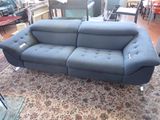 a blue couch that is on a rug in a room