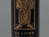 a black bottle with a gold design on it