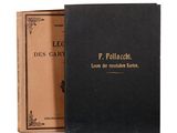 an old book with a black cover sitting on top of a table
