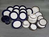 a pile of blue and white plates and bowls