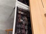 many pairs of glasses sitting in a drawer in a store