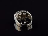 an image of a silver ring with diamonds on a black background