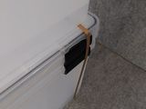 a white refrigerator with a black handle on the door