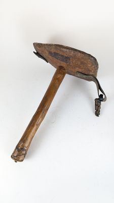 a small wooden object that is sitting on a white surface