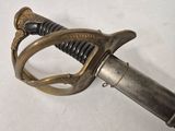 a sword that is laying on a white surface