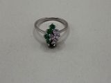 a close up of a silver ring with a green and white stone