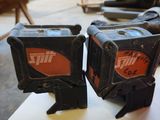 two black and orange tools sitting on top of a table
