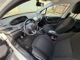 the interior of a small car with a steering wheel and dashboard