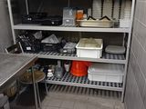many pots and pans on the shelves in the kitchen