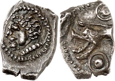 a close up of two silver coins on a white surface