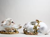 two figurines of animals that are sitting on top of each other