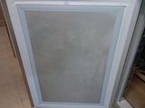 a refrigerator with a glass door in the middle of a kitchen