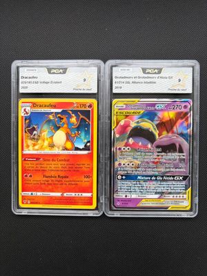 two pokemon cards are sitting next to each other on a table