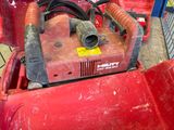 a red machine that is sitting on the ground