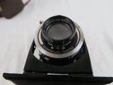 a black camera with a silver lens on top of it
