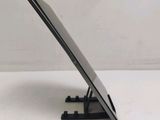 a close up of a tablet computer on a stand on a white surface