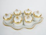 a tray with six cups and a saucer on it