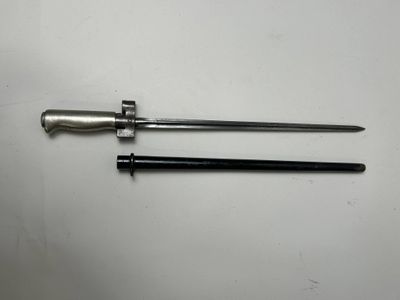 a pair of metal tools sitting on top of a white table
