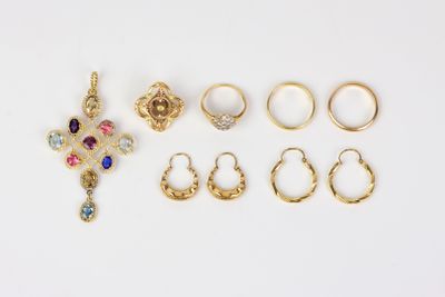 a group of rings and ear rings on a white surface