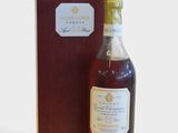 a bottle of whisky sitting next to a wooden box