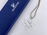 an image of a blue gift box with a snowflake ornament on it