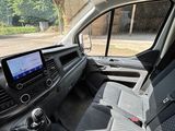 the interior of a van with a flat screen tv in the passenger seat