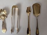 a lot of silver spoons and spoon spoons on the table