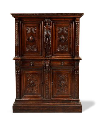 an oak cabinet with carved panels and carvings on the doors