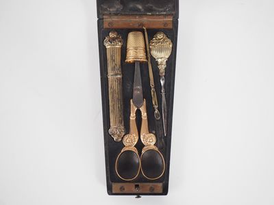 a wooden box with a set of scissors and a pair of scissors in it