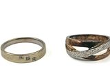 two rings with different designs on them sitting next to each other