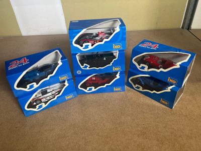 three boxed boxes of toy cars are sitting on the floor