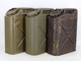three metal cans are lined up in a row on a white surface