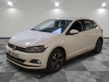 the white volkswagen polo is parked in a room with a checkered floor