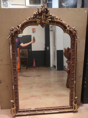 a man taking a picture of a mirror in a room