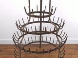 an image of a metal wine rack on a wooden floor