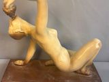 statue of a woman laying on her back on a marble base