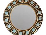 une image représentant un miroir rond rehaussé de touches de bleu et d'or