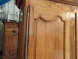 a large wooden armoire in a room with a blue ceiling