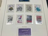 an open book with stamps on it on a table