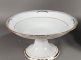 pair of white and gold footed bowls with gold rims