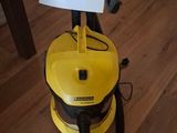 a yellow vacuum cleaner that is on a wooden floor