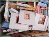 a box full of doll houses and other toys