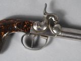 a close up of a gun on a white surface