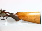 an old gun with a wooden barrel on a white surface